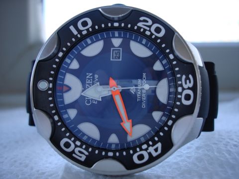 1994 Ford Bronco - Close-up of a blue Citizen Eco-Drive dive watch, orange hands and a date display.