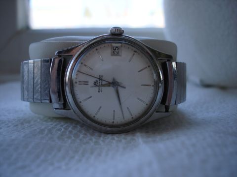 1994 Ford Bronco - A vintage wristwatch with an automatic movement is displayed on a textured surface.