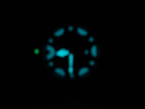 1994 Ford Bronco - A dimly lit and out-of-focus view of a vehicle's dashboard gauge cluster at night.