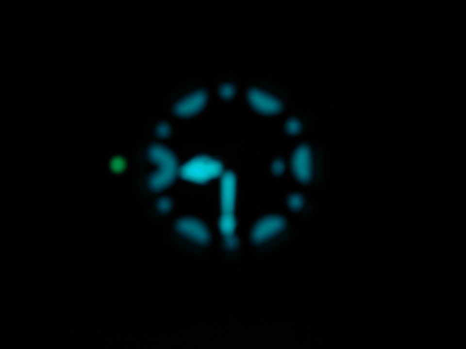 Blurred dashboard gauge cluster with blue and green lights