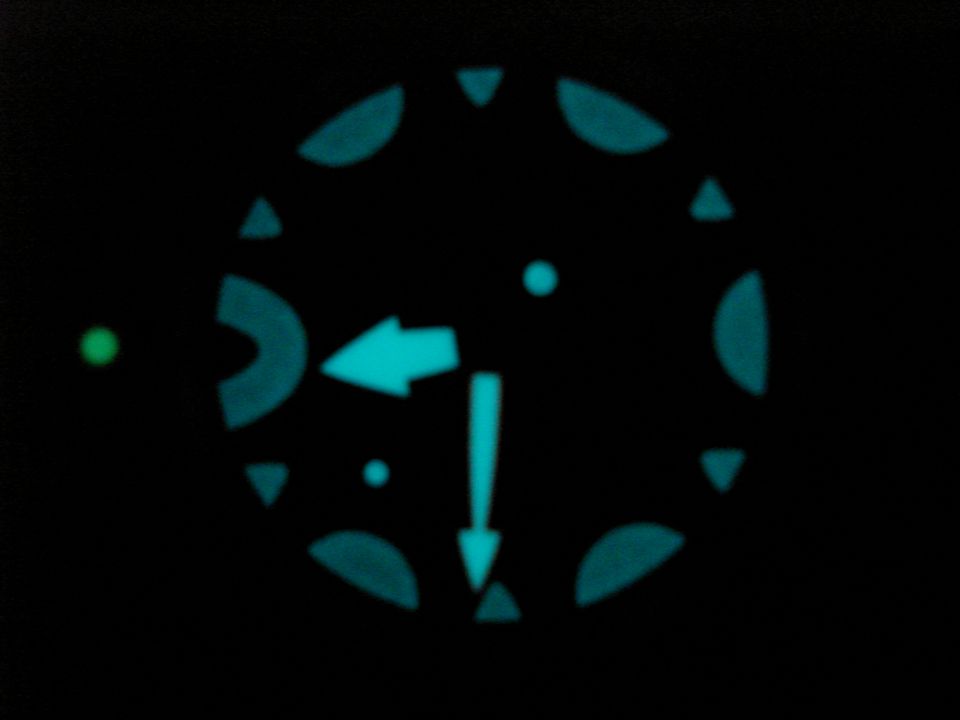 Illuminated gauge cluster with arrows and markers on black background