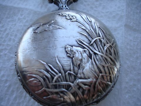1994 Ford Bronco - Detailed engraving on a silver pocket watch case depicts a hunting scene with a dog and birds.