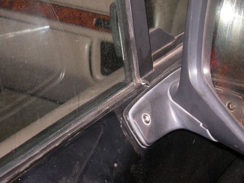 1996 Ford Bronco - Interior view of a car's door panel and window frame, showing trim details.