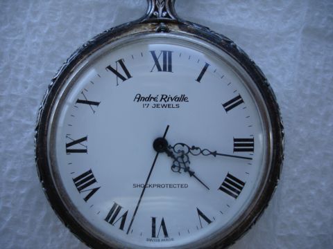 1994 Ford Bronco - Close-up of an André Rivalle pocket watch Roman numerals and 'Shockprotected' text.