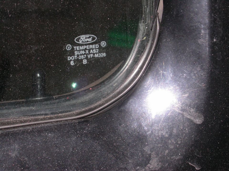 Close-up of Ford tempered glass with markings