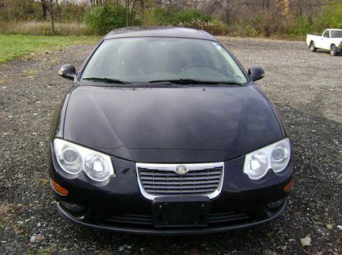 2002 Chrysler 300M - Front view of a black 2002 Chrysler 300M sedan parked outdoors, with a white pickup truck visible in the distance.