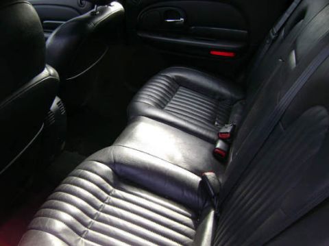 2002 Chrysler 300M - The plush black leather interior of a 2002 Chrysler 300M, ribbed seat cushions and seatbelts.
