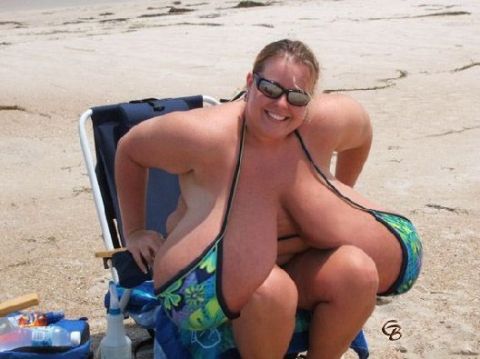 1978 Ford F-250 - Woman in a bikini relaxes on a beach chair, smiling at the camera.