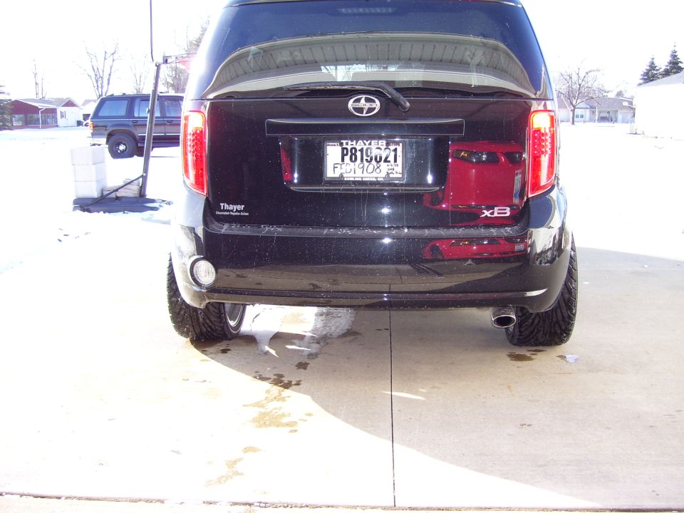 Rear view of black Scion xB parked on snowy driveway