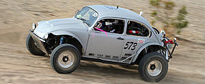 1990 Ford Bronco - Modified Volkswagen Beetle racing on a desert terrain.