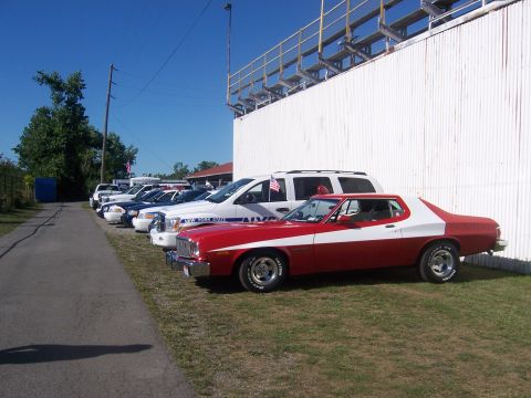 1975 Ford Torino - Red and white 1975 Ford Torino coupe parked in a line with other vehicles.