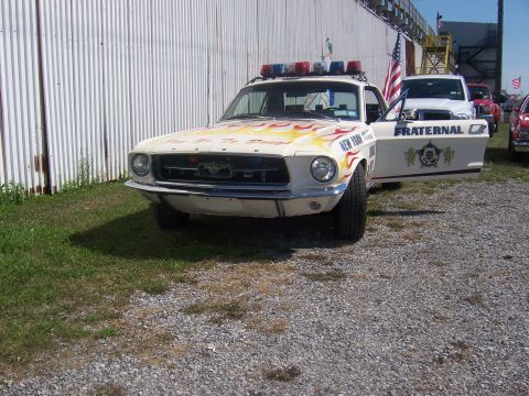 1975 Ford Torino - This modified police car features flame decals and a light bar, with 'New York Police' visible on the fender. It resembles a 1967 Ford Must…
