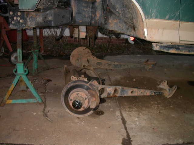 Ford Bronco suspension assembly on jack stands, showing brake rotor and control arm