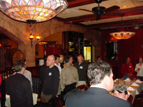 1990 Ford Bronco - A group of people are socializing in a restaurant with decorative lighting and exposed brick walls.