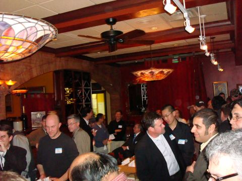 1990 Ford Bronco - Attendees mingle at an indoor event with decorative lighting and red drapery.