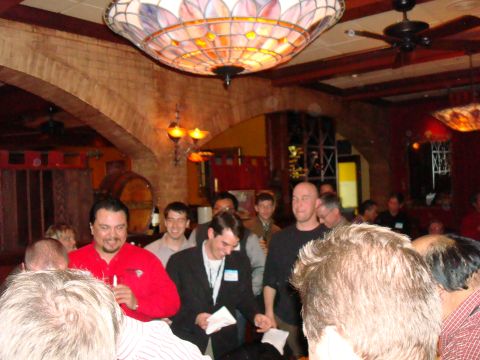 1990 Ford Bronco - Attendees mingle at an indoor event, with a prominent stained-glass chandelier overhead.
