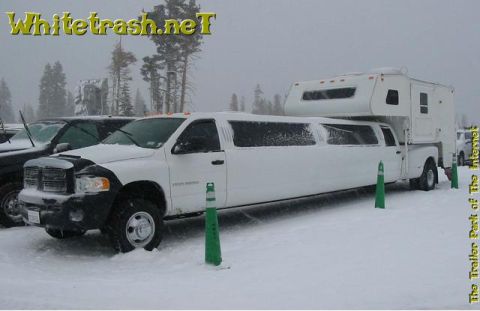 1989 Ford Bronco - A stretched pickup truck, modified into a limousine and fitted with a camper, sits in a snowy lot.