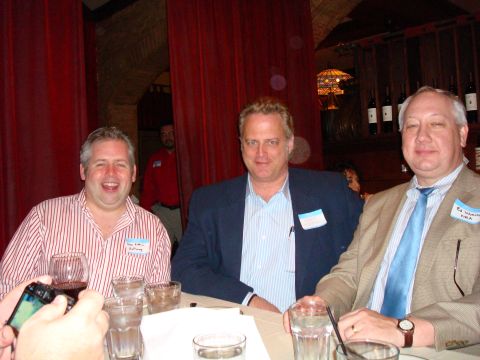 1990 Ford Bronco - Three men are seated at a table in what appears to be a restaurant or event space.