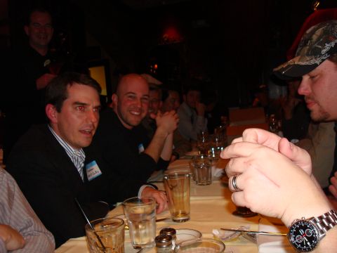 1990 Ford Bronco - A group of men are gathered around a table, appearing to be at a social event or dinner.