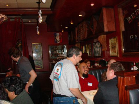 1990 Ford Bronco - A group of people are socializing in a dimly lit restaurant with red walls and decorative elements.
