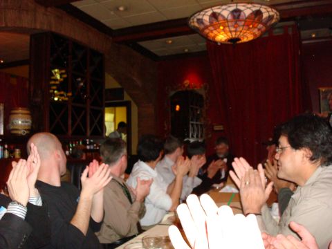 1990 Ford Bronco - A group of people are seated at a table, clapping their hands in a restaurant setting.