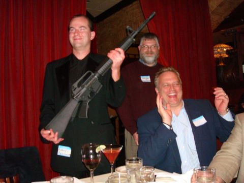 1990 Ford Bronco - Three men pose for a photo at a table, one holding a rifle.