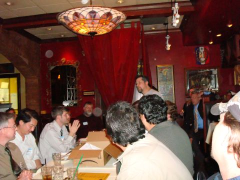 1990 Ford Bronco - Diners converse at a table in a restaurant, with a man standing in the background.