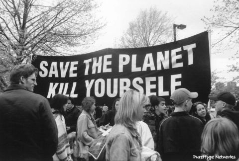 1989 Ford Bronco - A group of people stand before a banner with a controversial environmental message.