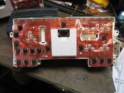 1994 Ford Bronco - Close-up of a vehicle's instrument cluster circuit board, showing electronic components and wiring.