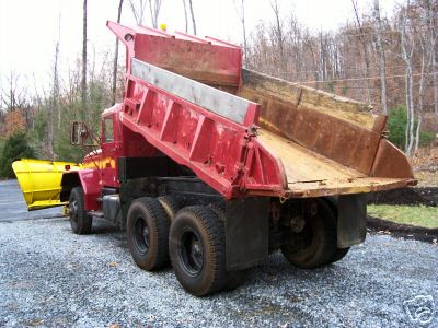 1968 Jeep CJ5 - Dump truck with snow plow attachment, rear view, bed in raised position.