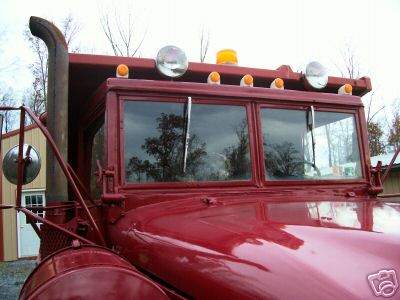 1968 Jeep CJ5 - Front view of a red truck cab a prominent vertical exhaust stack and dual windshields.