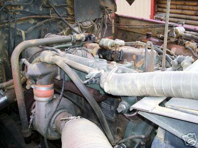 1968 Jeep CJ5 - Close-up view of a vehicle's engine compartment, showing various mechanical components and hoses.
