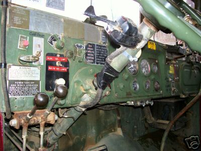 1968 Jeep CJ5 - The interior of a military-style truck shows a complex dashboard with multiple gauges and controls.