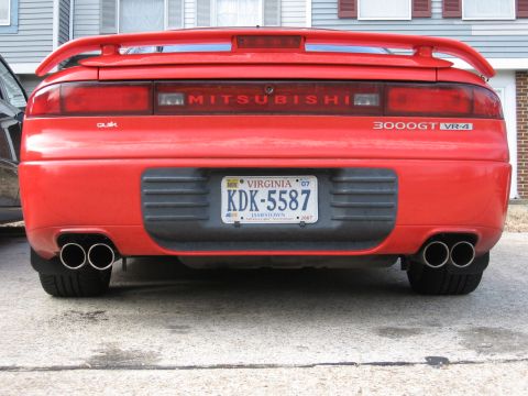 1991 Mitsubishi 3000GT - Rear view of a red 1991 Mitsubishi 3000GT VR-4, showing its distinctive taillights and dual exhaust.
