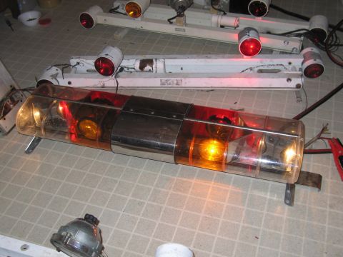 1991 Ford Crown Victoria LTD - A police light bar with red and amber lights is shown, along with other light fixtures.