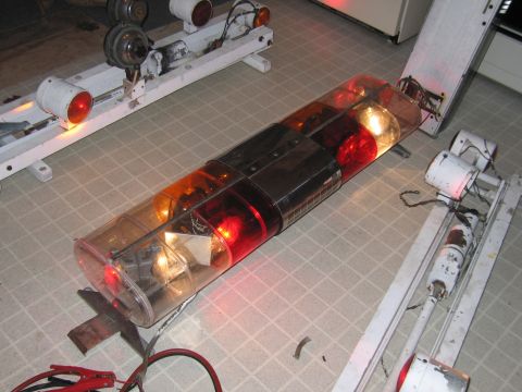 1991 Ford Crown Victoria LTD - A close-up view of an emergency light bar with red and amber lights, likely for a police vehicle.