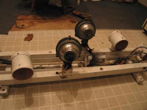 1991 Ford Crown Victoria LTD - A light bar assembly with multiple spotlights and visible wiring is shown on a tiled surface.