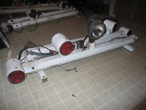 1991 Ford LTD Crown Victoria - A white police light bar with multiple lights and a spotlight is shown on a tiled floor.