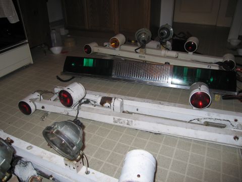 1991 Ford LTD Crown Victoria - Multiple police light bars, some with red and amber lights, are disassembled and placed on the floor.