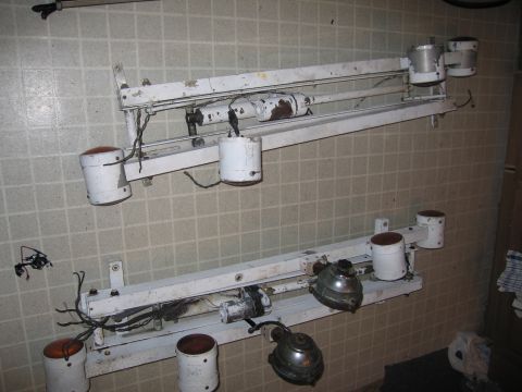 1991 Ford LTD Crown Victoria - Two white light fixtures with orange lenses are mounted on white bars against a tiled wall.