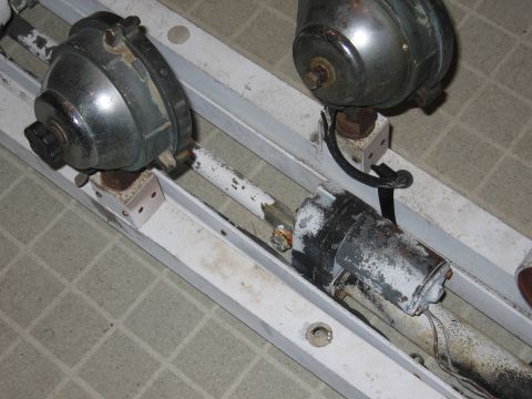 1991 Ford LTD Crown Victoria - Close-up view of two motors attached to a metal frame, showing mechanical components and wiring.