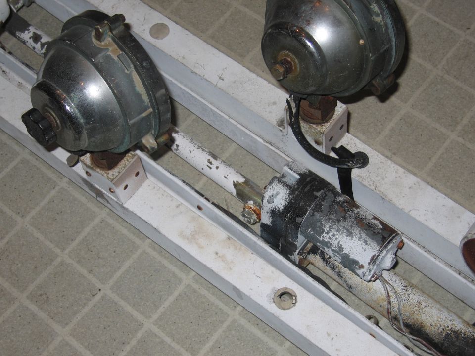 Two motors mounted on a white metal frame with visible wiring