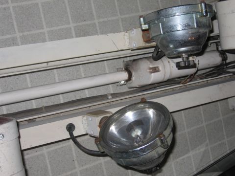 1991 Ford LTD Crown Victoria - Industrial spotlights mounted on a track, likely for area lighting.