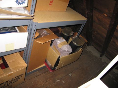 1991 Ford LTD Crown Victoria - Attic storage area with shelves holding various boxes and containers.