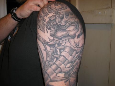 1995 Ford Bronco - A detailed tattoo of a demon mask covers the subject's arm.