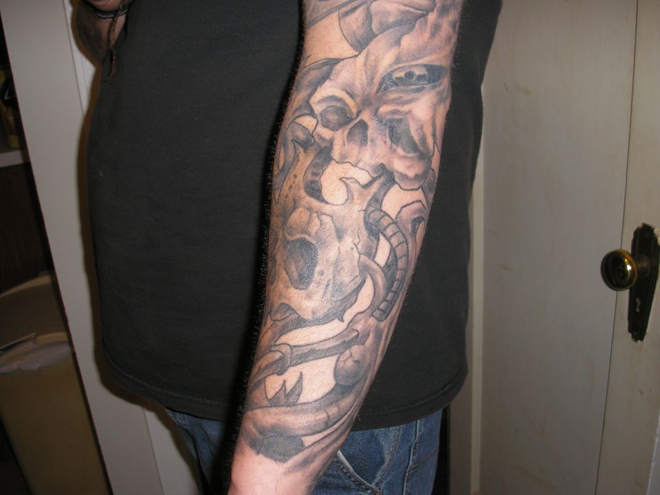 man's arm with a detailed skull tattoo