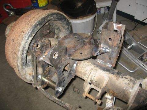 1990 Ford F-250 - Custom fabricated brackets welded onto a rear axle assembly with a brake drum.