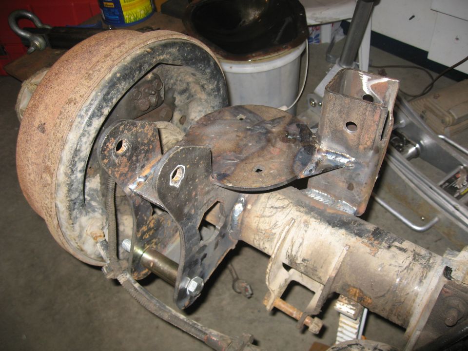 Rear axle assembly with brake drum and custom fabricated bracketry