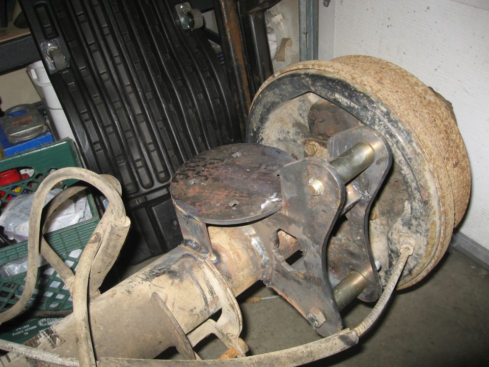 Close-up of a vehicle's rear axle assembly with a brake drum