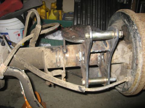 1990 Ford F-250 - Custom bracketry is welded onto a rear axle assembly, likely for suspension modification.